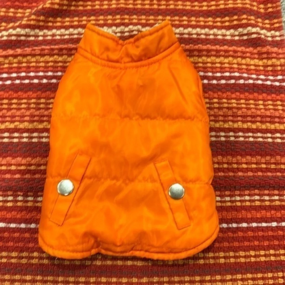 Small orange dog vest pockets are for decoration only.